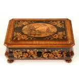 A French walnut, amboyna, ebony, marquetry and penwork bombe box, c1880, decorated to the front with
