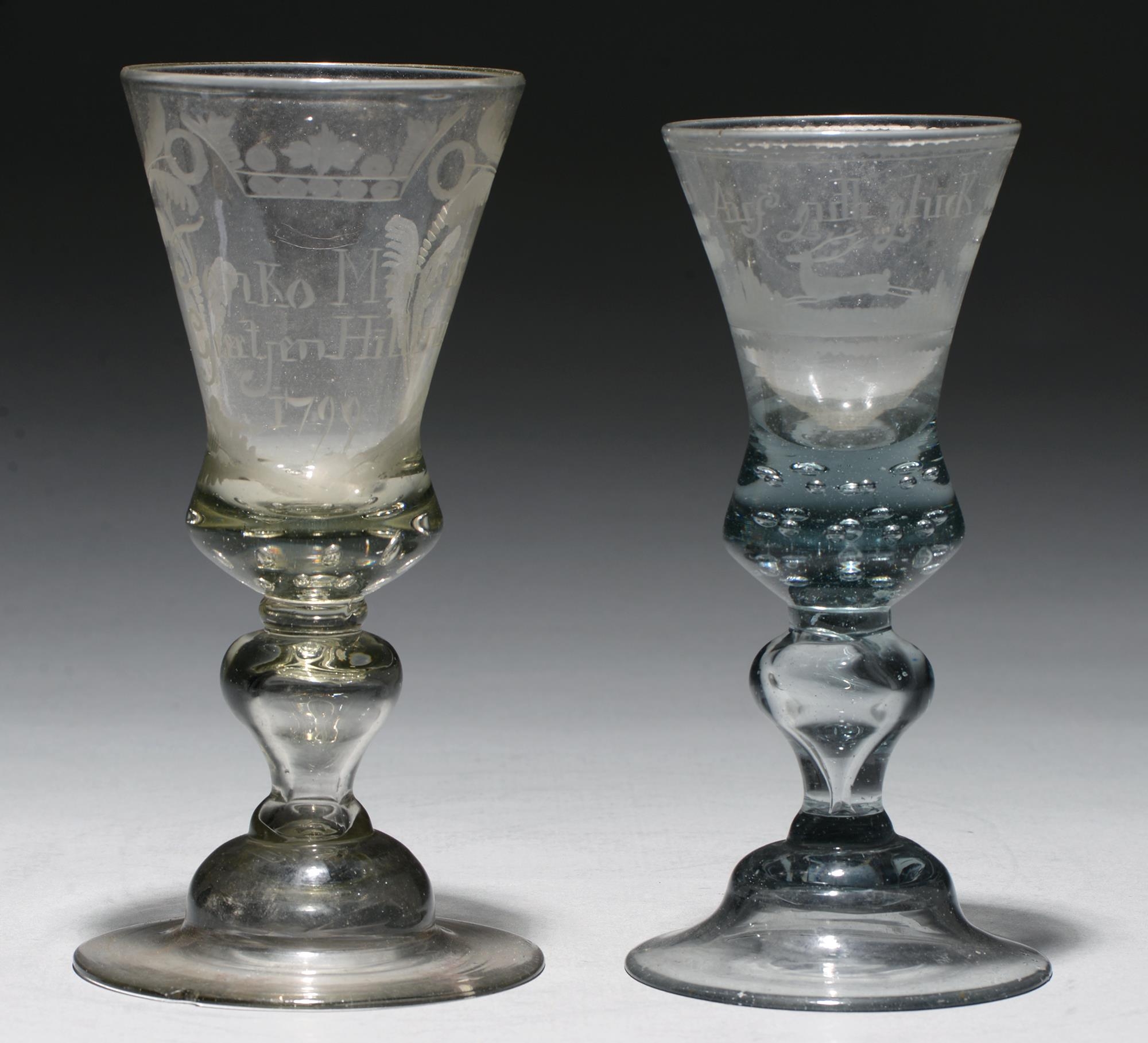 Two Bohemian glass goblets, late 18th c, soda metal, the thistle shaped bowl engraved with stag