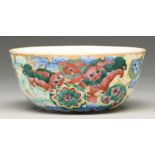 A Chinese porcelain bowl, late 19th c, richly enamelled and gilt with dogs of Fo, a pomegranate to