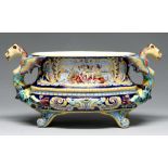 A French faience cistern, 20th c, with winged and fish tailed grotesque handles, the oval bowl