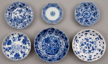 Six Chinese blue and white saucers, Kangxi period, one petal-moulded, each painted with a
