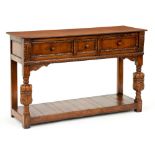 A Charles II style oak dresser, 20th c, with three moulded drawers flanked by carved acanthus on