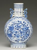 A Chinese blue and white moon flask, 19th c, painted to either side with dragons and peony