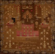 A Victorian wool sampler, Mary Owen aged 13 years 1867, worked with a fortified house, crowns,