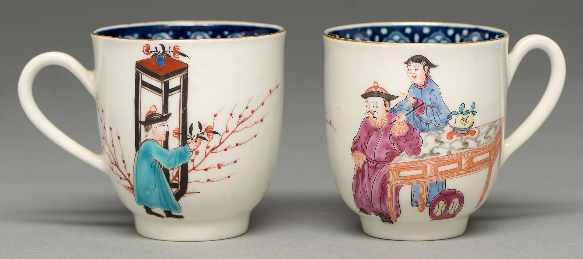 Two Worcester coffee cups, c1765, with underglaze blue border and painted with three Chinese