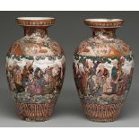 A pair of Japanese earthenware vases, early 20th c, enamelled with a continuous scene of Sennins and