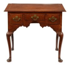 A George III oak lowboy, the moulded top with cleated ends and fitted three moulded drawers about