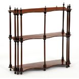 A set of George III mahogany hanging shelves, the three figured serpentine shelves with six