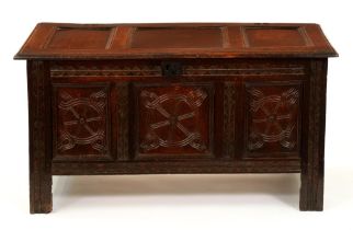 A Charles II oak chest, with three-panel lid, the three panels to the front carved with 'tulip'