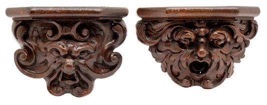 Two oak misericords, 19th c, each in the form of a grotesque mask, 22 and 23cm h Both complete and