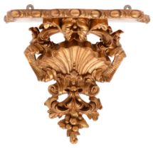 A gold painted and composition wall bracket, late 19th / early 20th c, the serpentine shelf on Venus