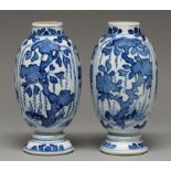 A pair of Chinese blue and white vases, 18th c or later, ovoid, painted with cross hatched trees