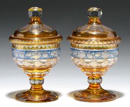 A pair of Bohemian amber flashed, blue enamelled and cut glass sweetmeat jars and covers, 20th c,