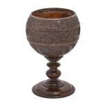 A coconut cup,  possibly French late 18th c, the bowl carved in three registers with trailing