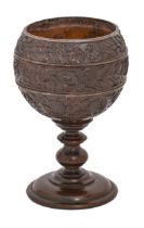 A coconut cup,  possibly French late 18th c, the bowl carved in three registers with trailing