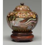 A Japanese cloisonne enamel jar and cover, enamelled with two phoenix beneath overlapping floral