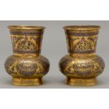 A pair of brass Cairo ware vases, with pierced neck and applied silver and copper decoration and