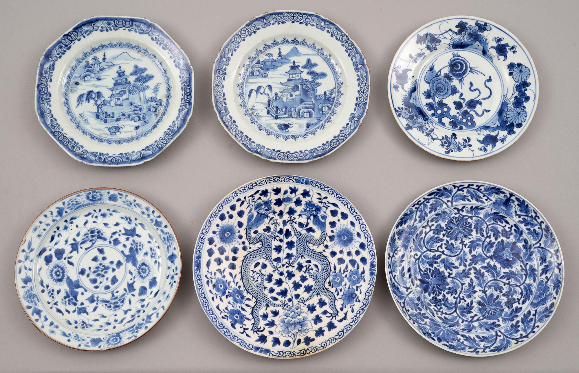 Four and a pair of Chinese blue and white plates, 18th and 19th c, painted with dragons, landscape