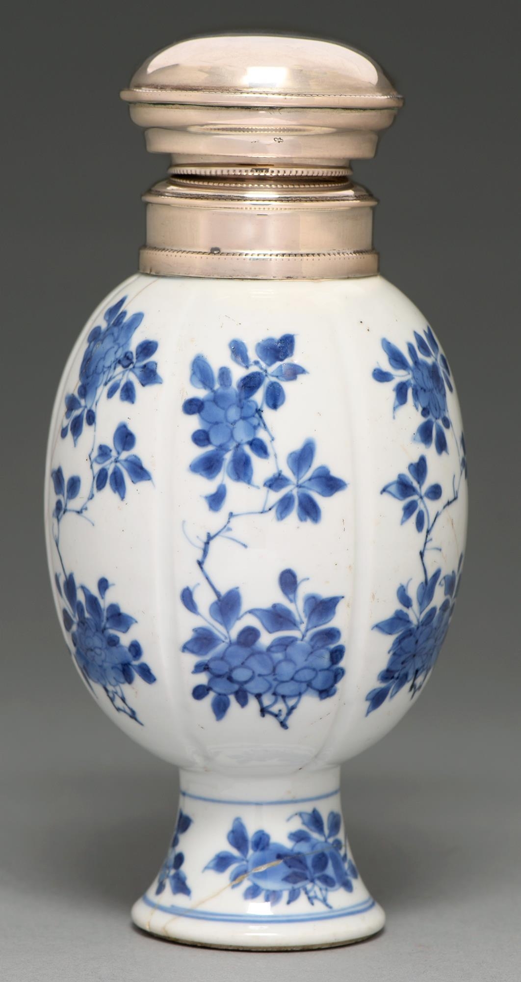 A Chinese blue and white vase, 18th c, lobed ovoid on flared foot, painted with flowering boughs