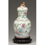 A Chinese Canton famille rose vase and cover, 19th c, enamelled with peafowl and other birds,