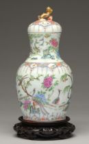 A Chinese Canton famille rose vase and cover, 19th c, enamelled with peafowl and other birds,