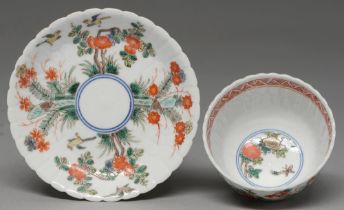 A Chinese fluted famille verte tea bowl and saucer, 18th c, painted in underglaze blue and enamelled