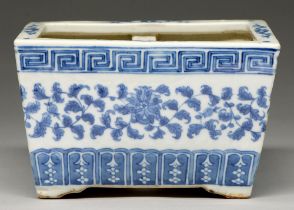 A Chinese blue and white jardiniere, late 19th / early 20th c, painted with lotus meander between