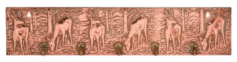A stamped sheet copper covered metal wall hanging key rack, probably 1930s, with deer and row of