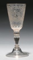 A German goblet,  18th c, the faceted, rounded funnel bowl engraved with two circular framed