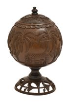 A coconut cup and cover, Sri Lanka, late 19th c, carved with a continuous scene of workers at a
