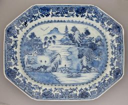 A Chinese blue and white dish, 18th c, painted with a river scene, the border with diaper, fret