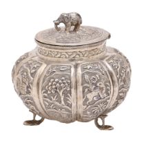 A South East Asian melon shaped silver repousse box, late 19th c, the lid with elephant knop, chased