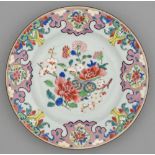 A Chinese famille rose plate, 18th c, painted with flowers and prunus in a border of pink lappets