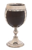 An English silver mounted coconut cup, early 18th c, the smooth husk of fine patina in three