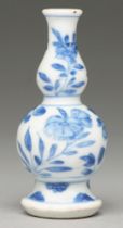 A Chinese blue and white double gourd vase, 18th c, painted with stylised flowers and foliage,