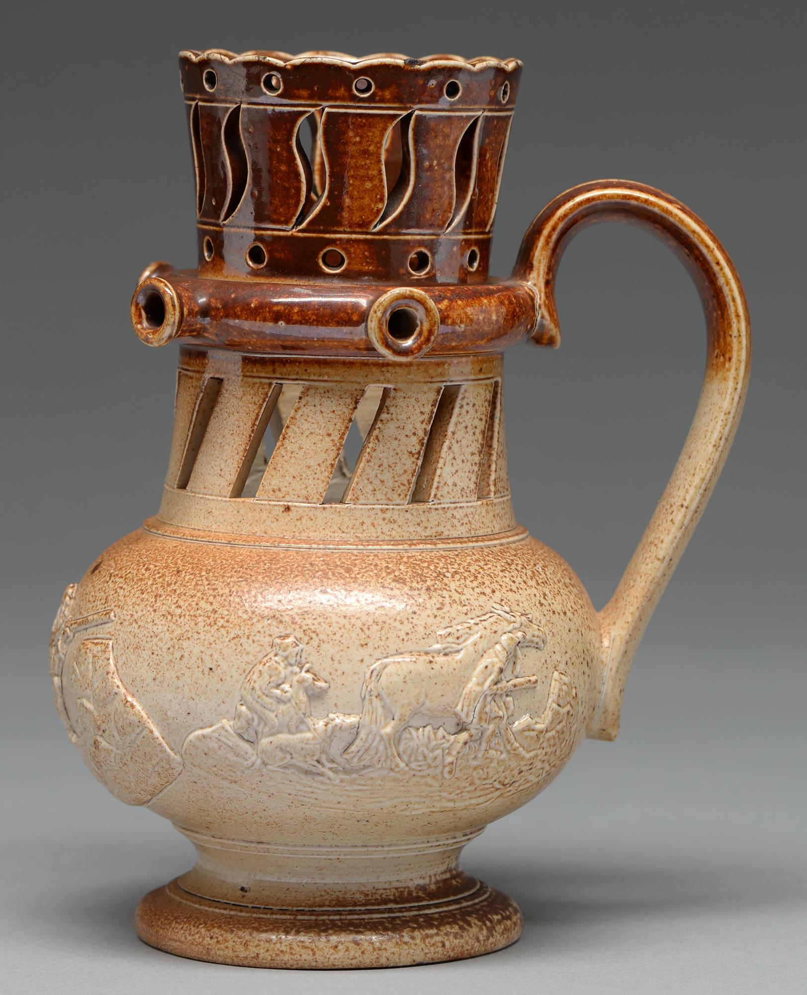 A Derbyshire saltglazed brown stoneware puzzle jug, probably Chesterfield, c1830, with three