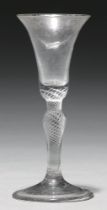 A wine glass, mid 18th c, the bell bowl with solid base on inverted baluster multi spiral air