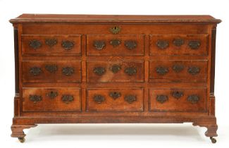 A George III oak mule or 'Lancashire' chest, the crossbanded lid with three plush brass hinges,