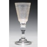 A German glass goblet,  18th c, the faceted tapering bowl engraved with flowers and foliage