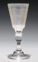 A German glass goblet,  18th c, the faceted tapering bowl engraved with flowers and foliage