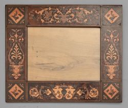 An Italian marquetry and olive wood frame, late 19th c, with birds, grotesques and urns, 30.5 x 36.