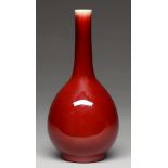 A Chinese flambe glazed vase, 20th c, of slender tapering bulbous form, the even rich glaze thinning