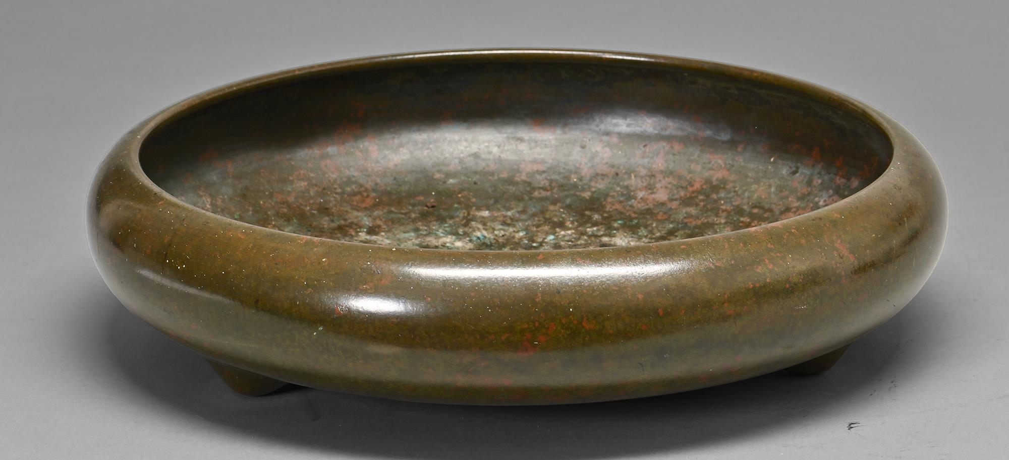 A Japanese bronze flower arrangement  bowl, Meiji period, of shallow rounded form with inverted