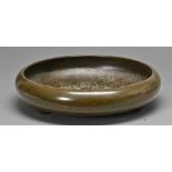 A Japanese bronze flower arrangement  bowl, Meiji period, of shallow rounded form with inverted