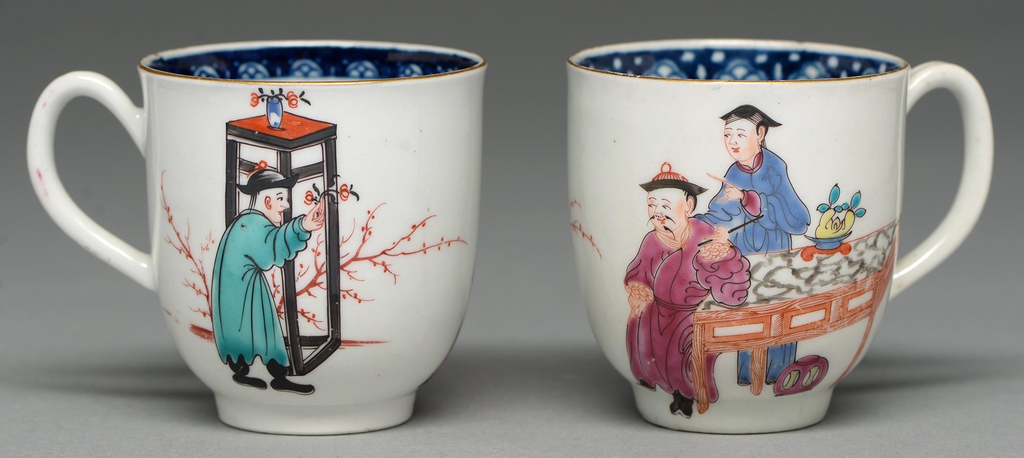 Two Worcester coffee cups, c1765, with underglaze blue border and painted with three Chinese