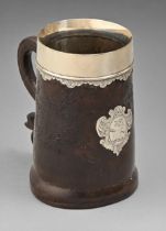 An English silver mounted leather mug, early 18th c, the shaped handle terminating in a flower,