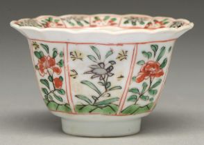 A Chinese famille verte tea bowl, Kangxi period, painted with flower panels to the exterior and