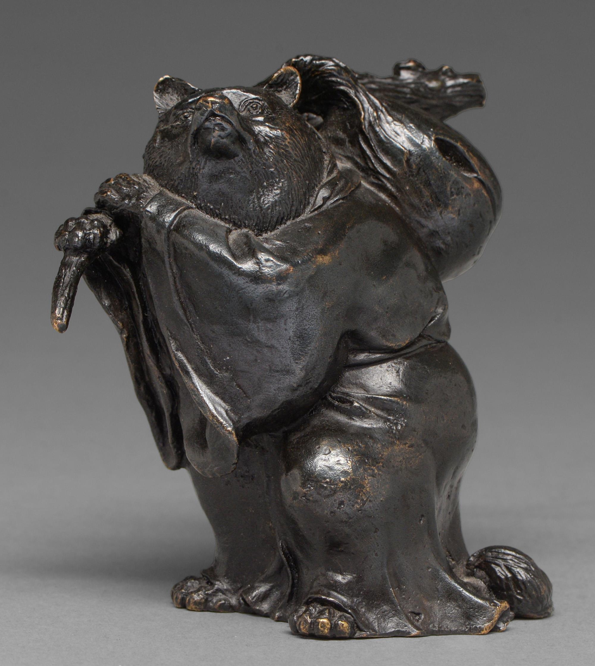 A Japanese bronze anthropomorphic okimono of a badger/racoon dog (Tanuki) as a priest carrying a