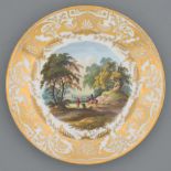 A Derby plate, c1820, painted with a landscape with a horseman and peasant in gilt anthemia