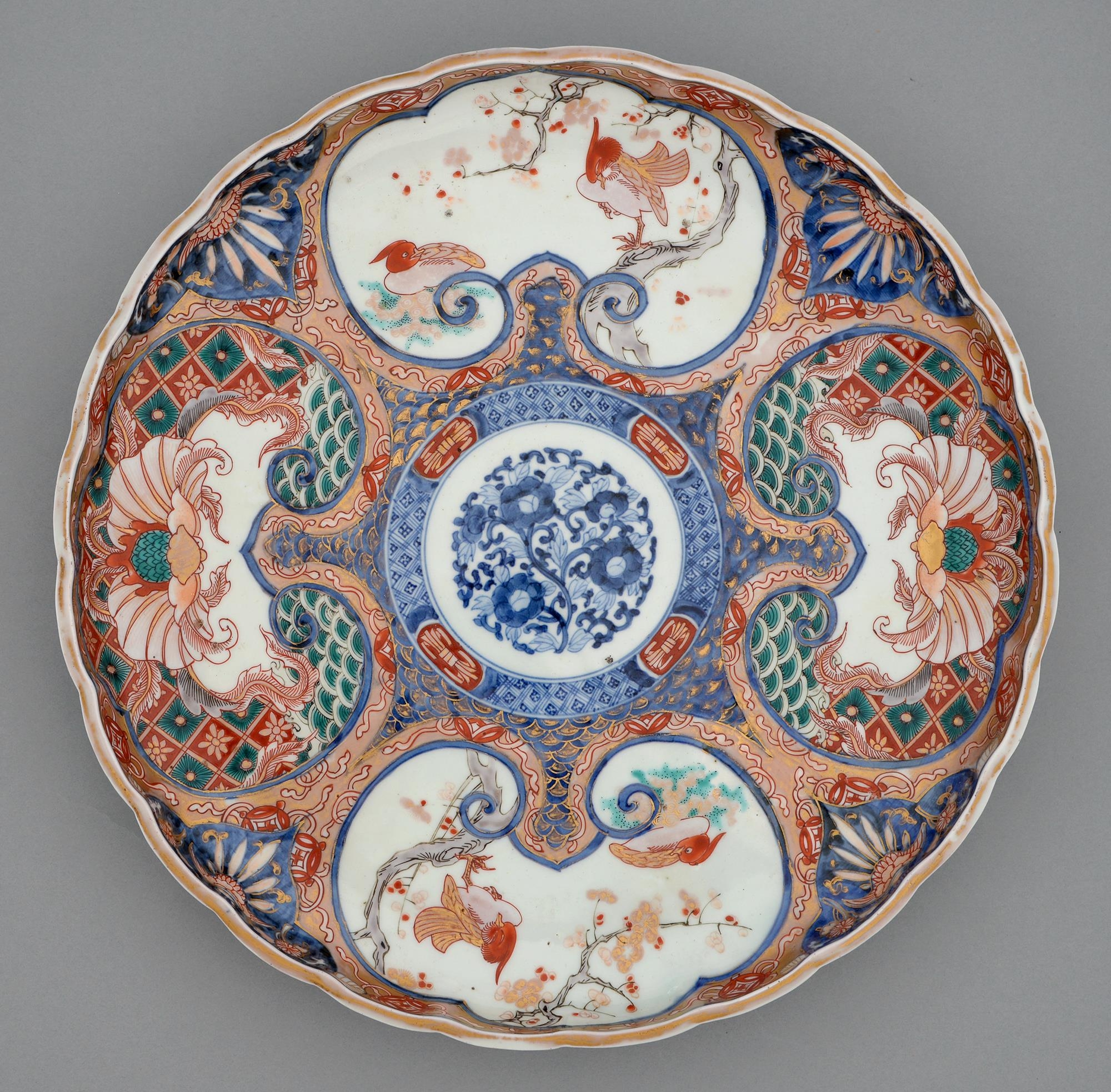 An Imari tray, Meiji period, painted in underglaze blue with a central floral medallion in diaper